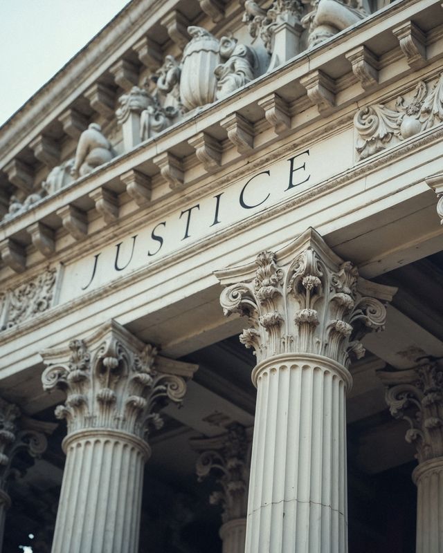 Courthouse facade engraved with the word Justice